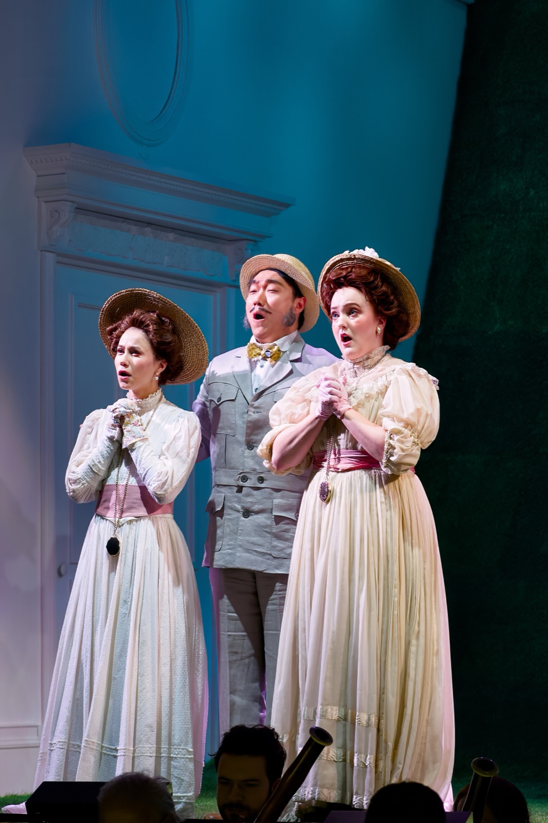 Veronica Richer in a white period costume on stage