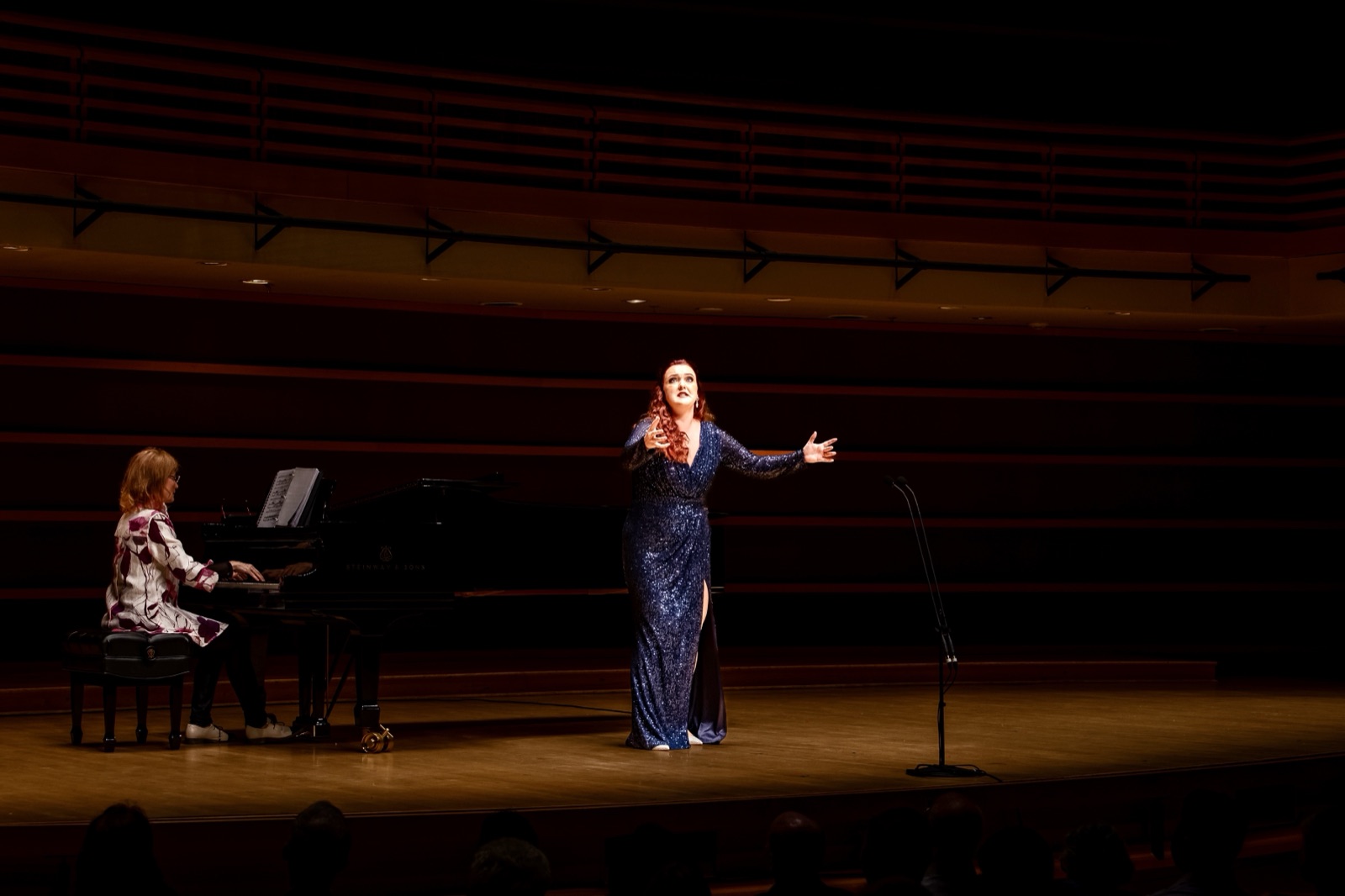 Veronica Richer in a blue gown in recital with pianist