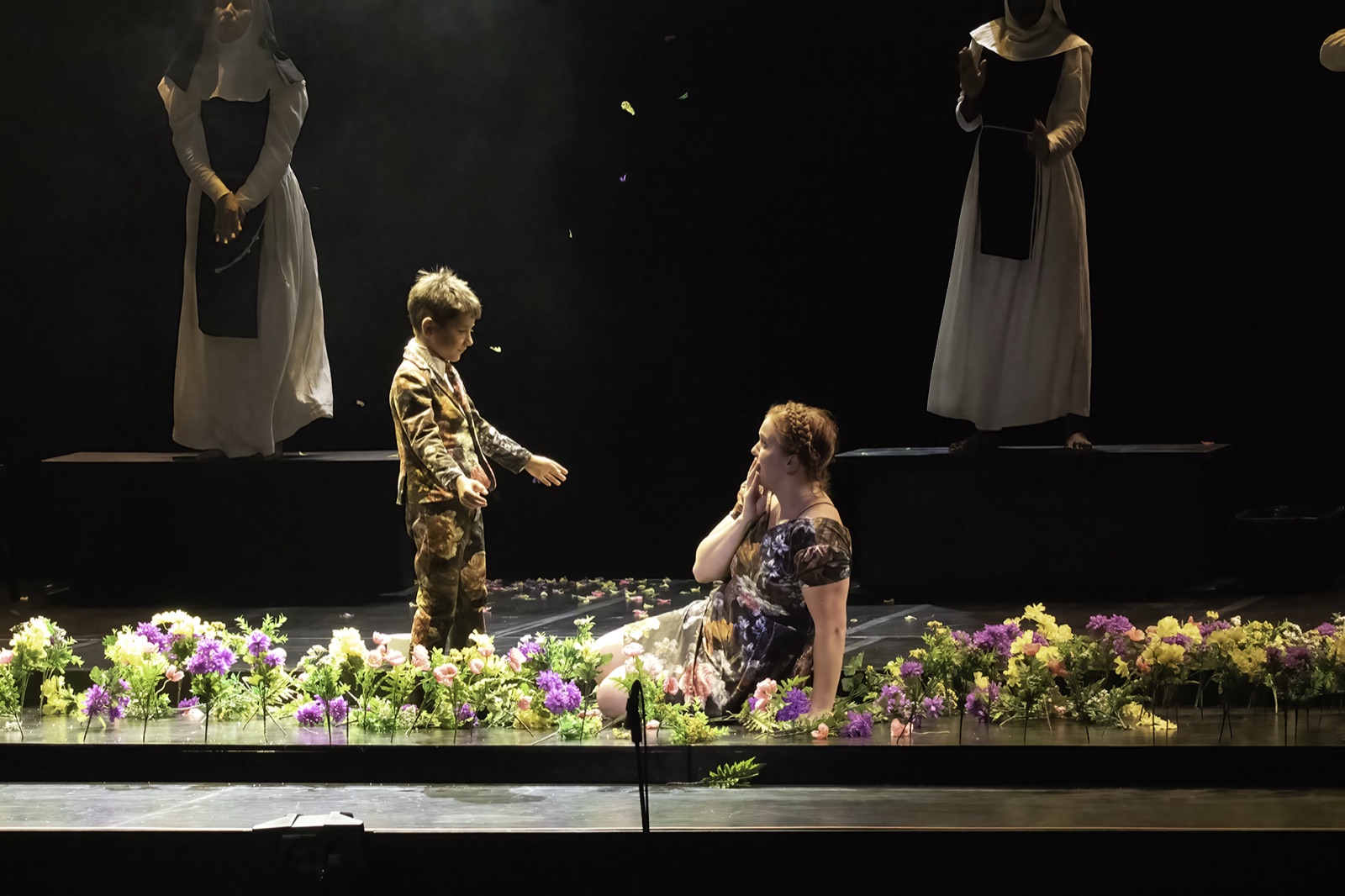 Veronica Richer on stage among flowers