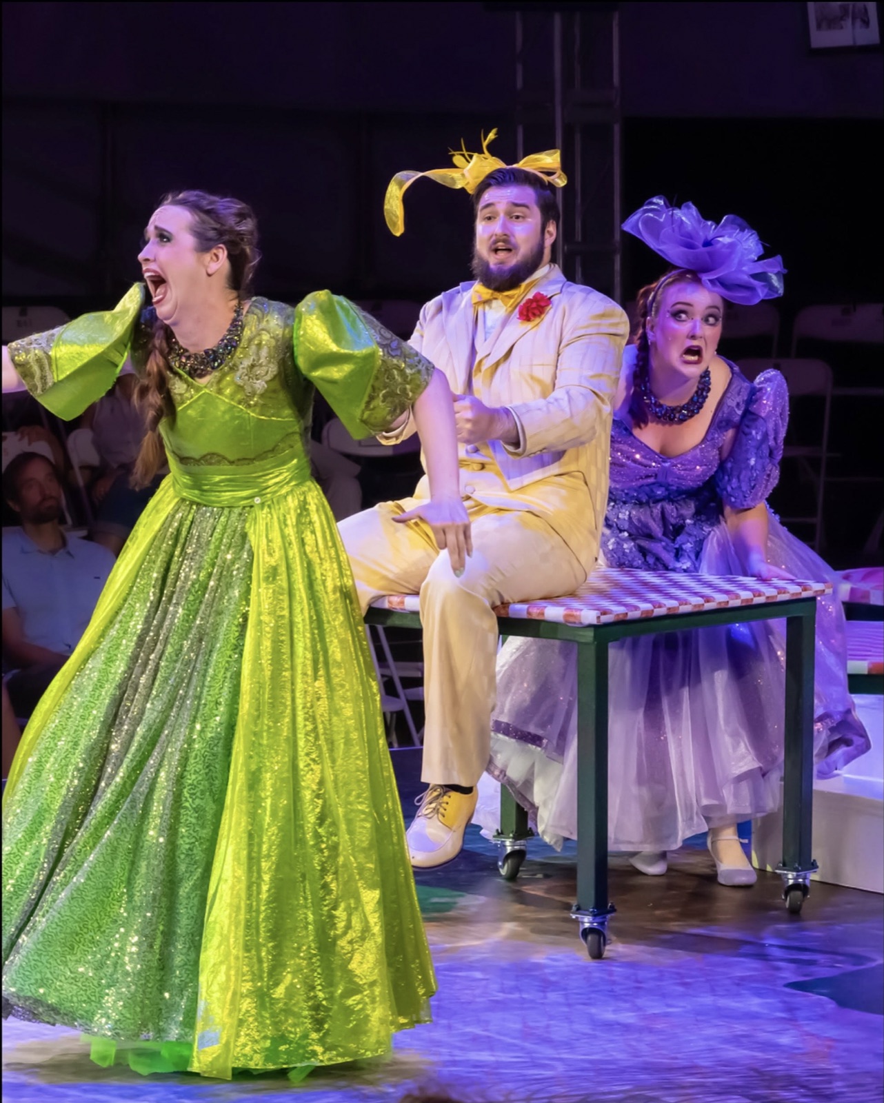 Veronica Richer in a purple gown and hat in La Cenerentola