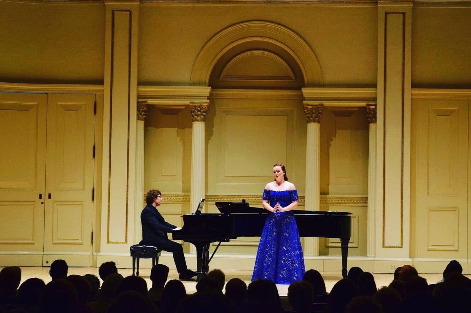 Veronica Richer in a royal blue lace gown in recital with pianist